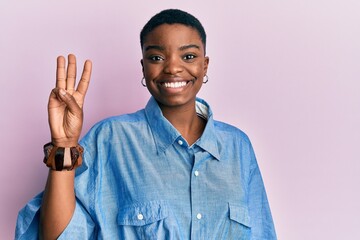 Young african american woman wearing casual clothes showing and pointing up with fingers number...