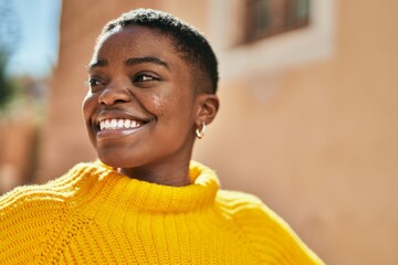 Young african american woman smiling happy standing at the city.