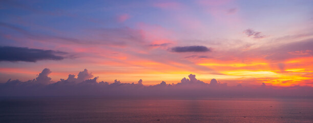 Beautiful dramatic and colorful sky at sunset over the sea, Banner panorama