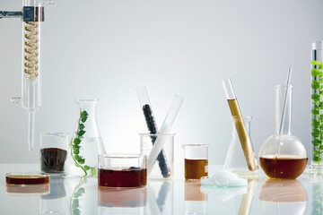 A front view of coffee extract decorated with laboratory equipment in white lab background