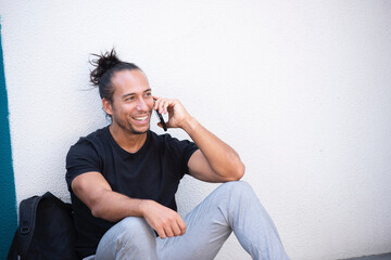 Happy man talking on mobile phone outdoors in city