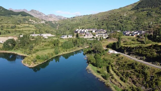 Sallent de Gallego at Tena Valley, Huesca, Aragon, Spanish Pyrenees, Spain - Aerial Drone View of the Mountain Village, Lake Embalse de Bubal and Motorhomes (Camper Vans)