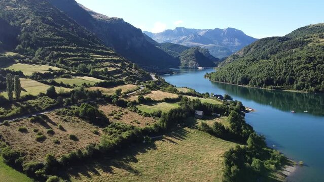 Lake Embalse de Bubal at Valle de Tena Valley in Huesca, Aragon, Spanish Pyrenees, Spain - Aerial Drone View of the Green Valley and Water Reservoir