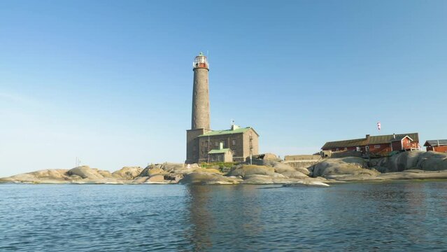 Historical lighthouse made of stone filmed from a moving boat
