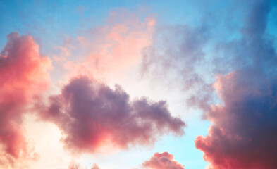 Light pink cumulus fluffy clouds in sunset blue sky. Pastel cloudscape colors gradient. Sunrise background. Natural sunset light. Paradise heaven abstraction. Concept of ideal morning mood wallpaper