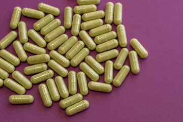 Top view of barley grass capsules on purple background