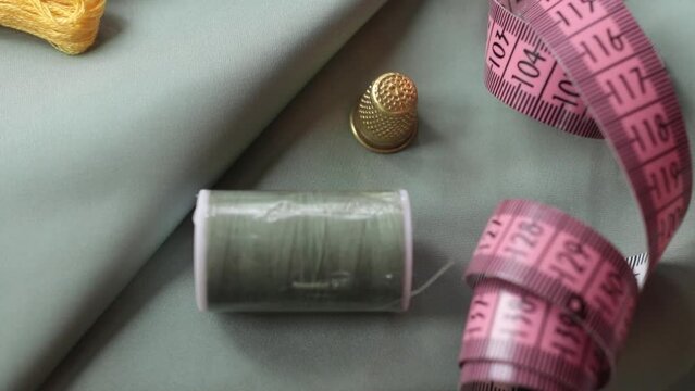 Close up shot of thimble and thread.  Tailor craft equipment  