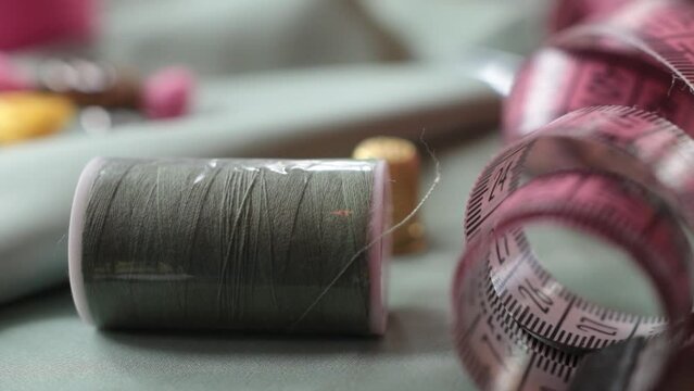 Close up shot of thimble and thread.  Tailor craft equipment  