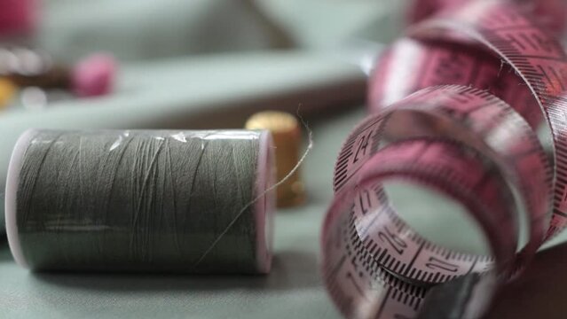 Close up shot of thimble and thread.  Tailor craft equipment  