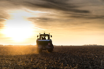 Fototapeta premium Tractor spreading artificial fertilizers in field