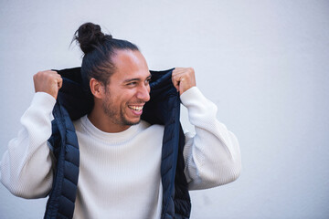 man in holding puffer jacket over white background