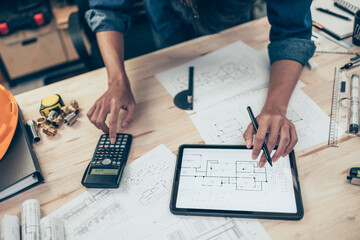Architect engineer use calculator for calculate drawing design working on blueprint. House planning...