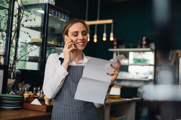 woman waitress talking on a mobile phone