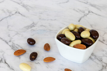 Almonds coated with chocolate. Mix of chocolate nut sweet snack.