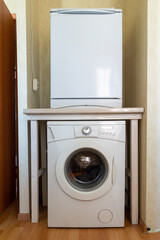 fridge above washing machine in small kitchen.