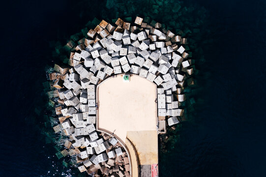 Aerial view of a breakwater at at Sant Feliu de Guixols harbour, Girona, Spain.