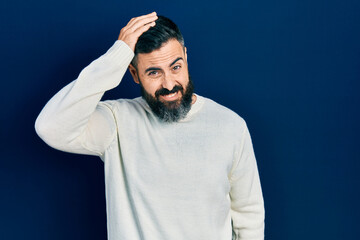 Young hispanic man wearing casual clothes confuse and wonder about question. uncertain with doubt,...