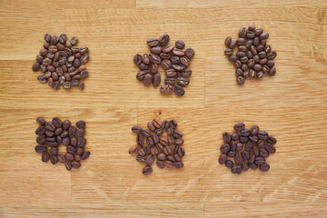 six different types of coffee on a wooden board