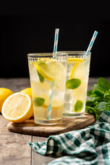 Glass of fresh lemonade on wooden table