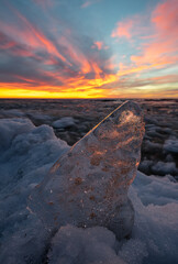 Close-up of piece of ice on snow on Baltic sea shore.
