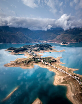 Aerial view of Rama Lake with a few buildings along the coast, Bosnia and Herzegovina.