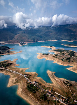 Aerial view of Rama Lake with a few buildings along the coast, Bosnia and Herzegovina.