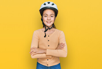 Beautiful brunette little girl wearing bike helmet happy face smiling with crossed arms looking at the camera. positive person.
