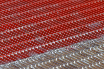 Closeup shot of metal surface with red and silver color