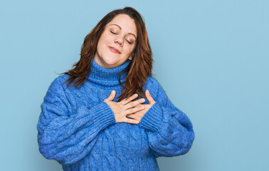 Young plus size woman wearing casual clothes smiling with hands on chest with closed eyes and grateful gesture on face. health concept.
