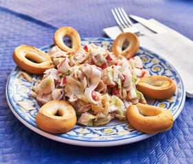  Plate of spanish salad on paper surface