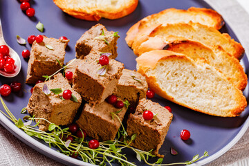 liver pate cubes on plate with toast and berries