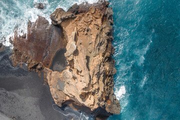 Aerial view of a rock formation along the coast near Playa El Golfo, Lago Verde (Green Lake), Lanzarote, Canary Islands, Spain.