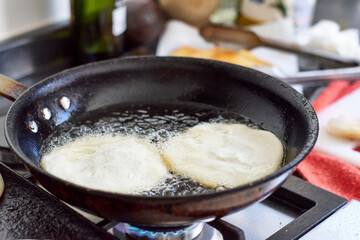 frying arepas in a pan