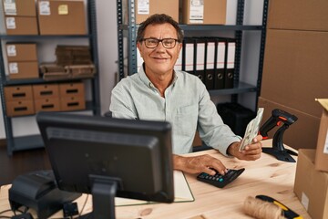 Middle age man ecommerce business worker counting dollars at office