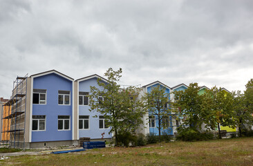 The progress of construction of the kindergarten building. Modern decoration of building facades