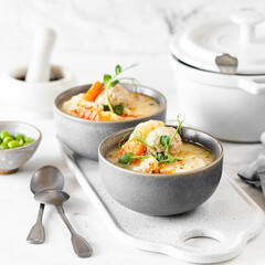 Step 5. Recipe for soup with meatballs, cauliflower, baby peas, carrots and cream on a white background. Square.