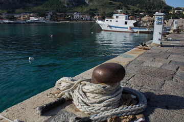 Obraz premium evocative image of the anchor point for boats in the port in a small fishing village in Sicily, Italy 