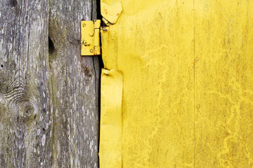 old metal door painted in yellow as a rural background