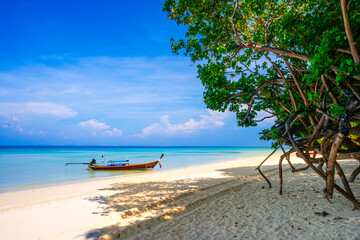 KRABI, THAILAND - Thai wooden motorboat, boat trips at sea, Clean white sand beaches, and emerald green sea.soft focus.