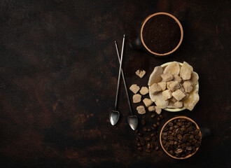 Bowls with dried ginger, brown lump and granulated sugar, coffee beans and ground coffee as...