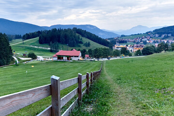 Maso Spilzi in the meadows of Folgaria and the village of Costa. Cimbra Alp, Trento province, Trentino Alto-Adige, Italy, Europe.