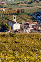 The San Vincenzo church of the village of Isera surrounded by the Vallagarina vineyards. Trentino,...
