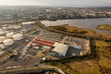 Aerial drone view on bus park and repair shop and oil supply base. Calm cloudy sky. Galway city,...