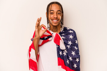 Young African American man holding a American flag isolated on white background cheerful and...