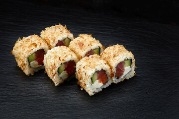 Japanese restaurant menu photo, seafood, national cuisine. Tuna and cheese sushi rolls set served on black plate, food background