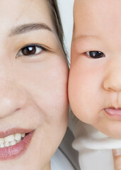 baby and mom asian closeup portrait, happy motherhood. mother and baby at home, selective focus