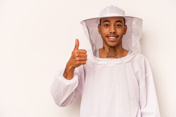 Young African American beekeeper isolated on white background smiling and raising thumb up