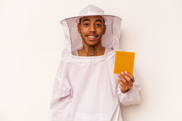 Young African American beekeeper isolated on white background happy, smiling and cheerful.
