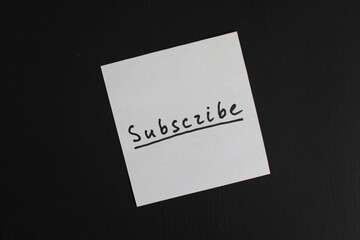 Subscribe Note on Black Background. Social networking and media management concept 