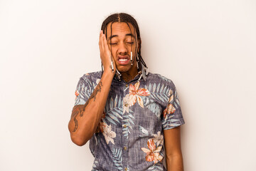 Young African American man isolated on white background tired and very sleepy keeping hand on head.